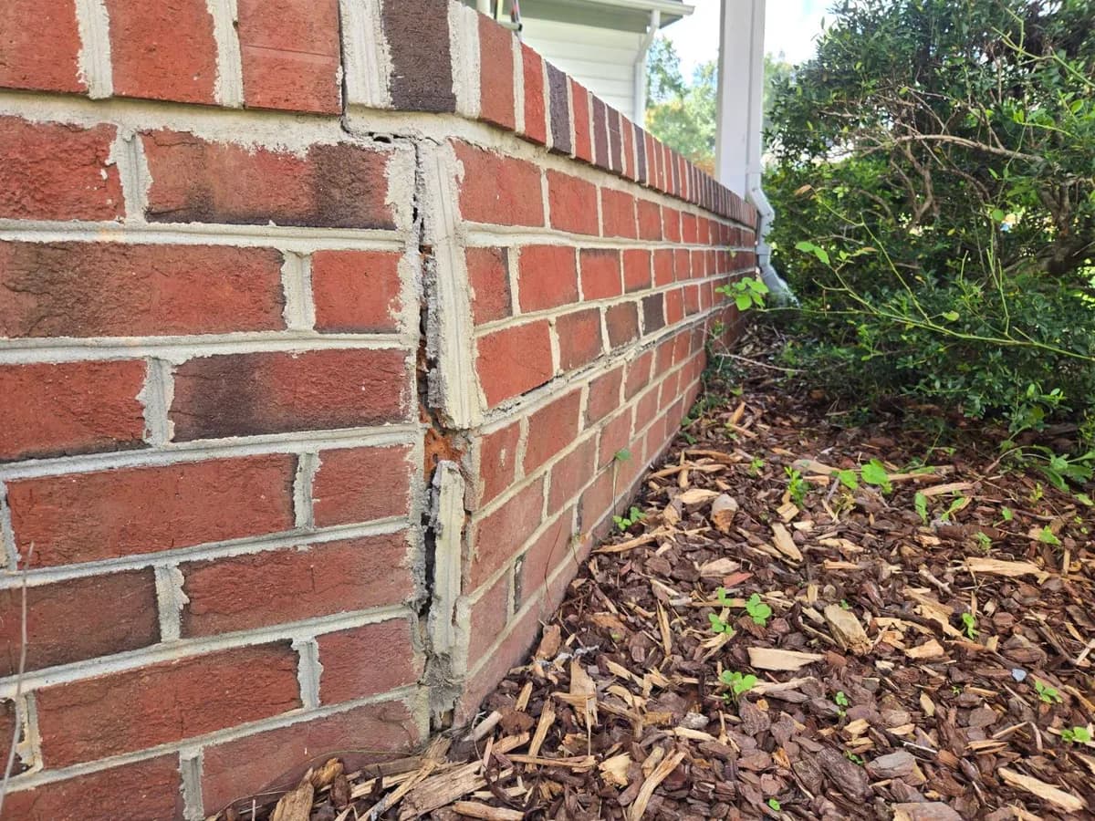 Vertical crack running through a brick foundation wall